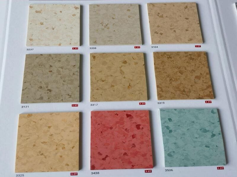 side by side material samples of commercial vinyl carpet tile and concrete
